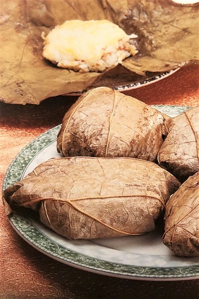 Lotus Leaf Sticky Rice Dumplings Served In Bamboo Steamer At Dim Sum